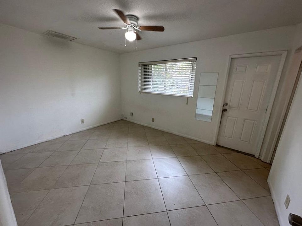 Bedroom with window and rear entry door