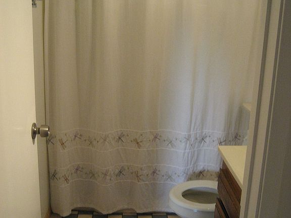 checkered tile flooring with new toilet