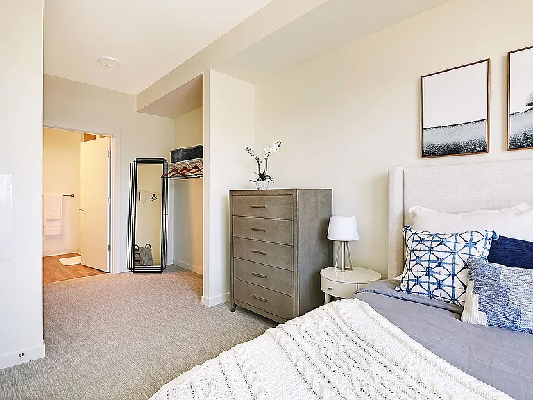 Experience serenity in this modern bedroom haven, designed for relaxation and comfort.