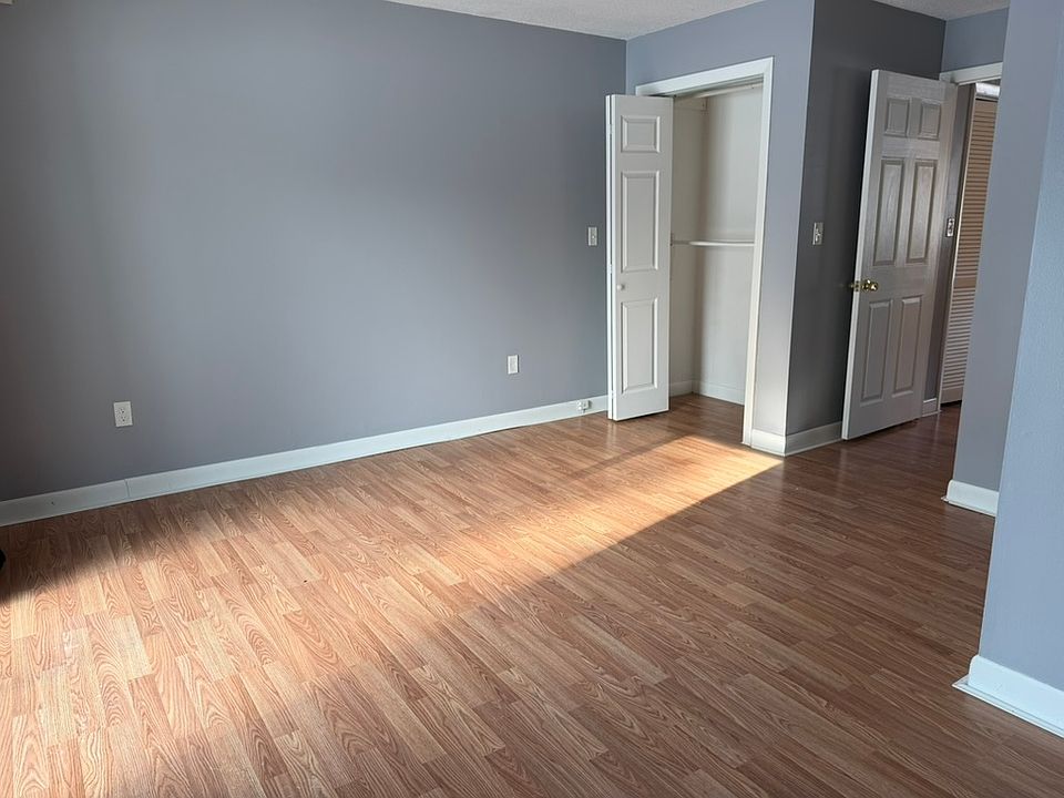 Sunny bedroom with attached bathroom, closet, and direct access to the patio.