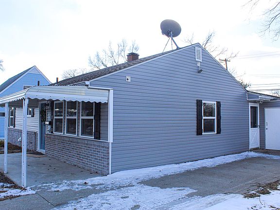 Side Entrance and Attached Storage Shed.