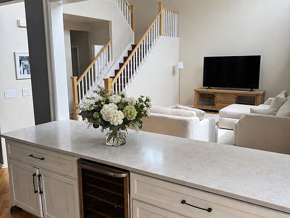 Custom built buffet counters with large, soft-close cabinets and drawers, including a built-in wine fridge. Space opens up and connects the living room and dining room. Perfect for hosting parties and holiday dinners.