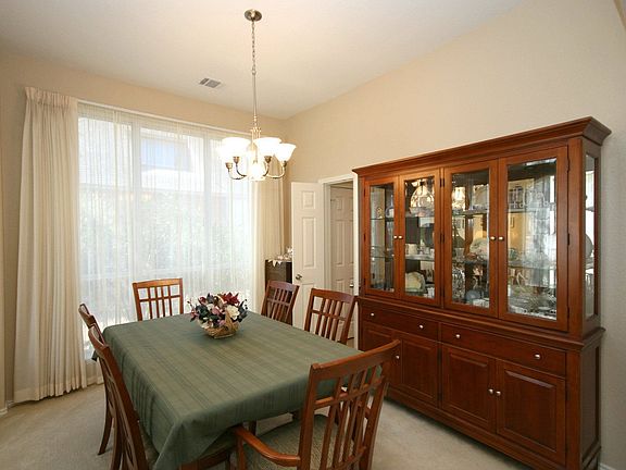 Formal Dining With Double Doors Leading To Kitchen