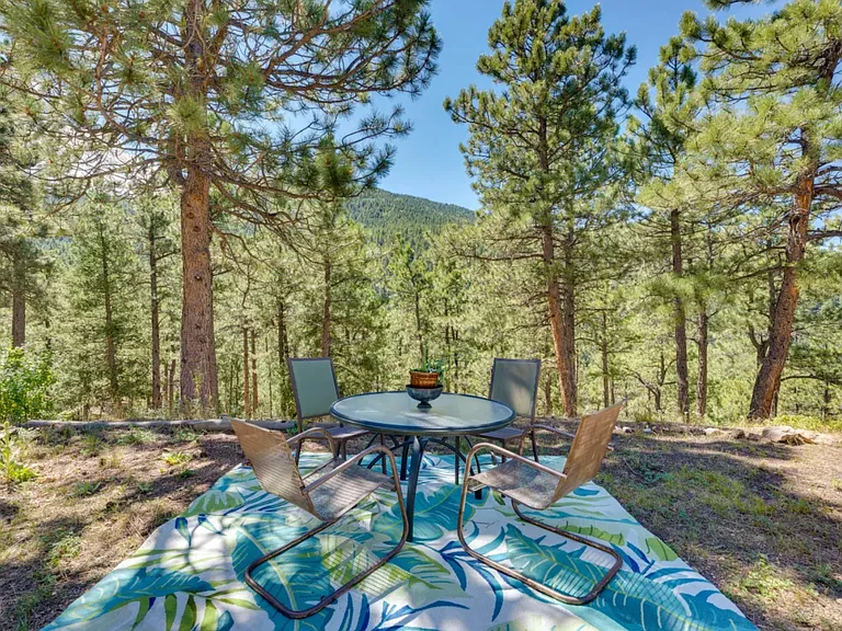 Backyard dining area by the view of Indian Peaks and yoga platform