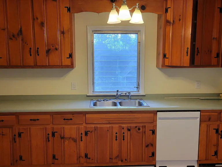 Kitchen new dishwasher, disposal, plumbing, microwave w/external vent over range.