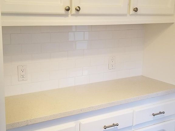 Additional cabinets and counter area opposite the kitchen sink