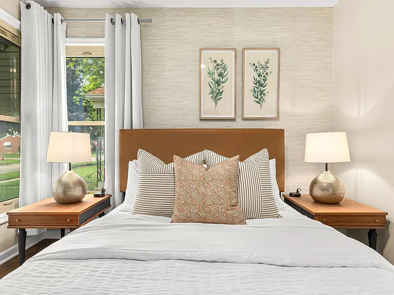 The large window lets in plenty of natural light, making the bedroom feel bright and airy.