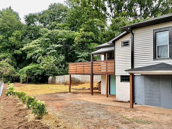 sunny deck, beautiful garden with flowery hedges
