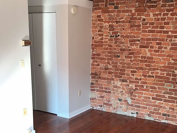 Living Area/Exposed Brick Wall/Closet