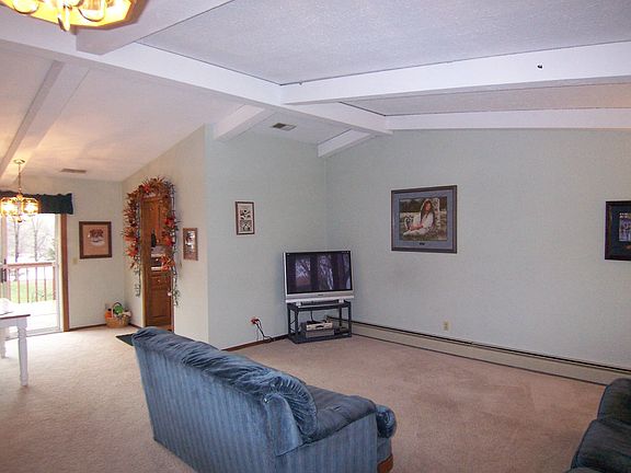 Vaulted living room with informal dining, and walk out to deck