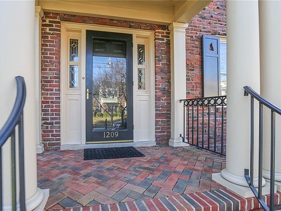 Classic , leaded side light windows, columns, wood shutters, decorative railings create the perfect entrance.