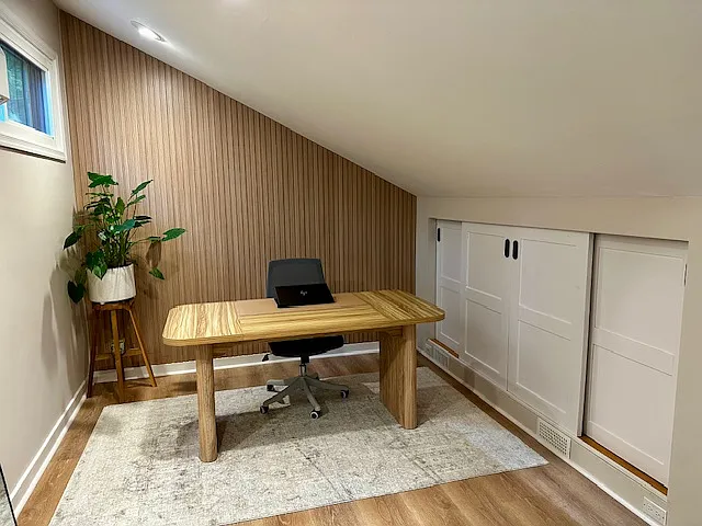 The remodeled loft is a bright and tranquil retreat, flooded with natural light and perfect as a quiet room or creative space. It features a separate AC unit to keep the area cool and comfortable on warm days. A cleverly concealed attic access door.