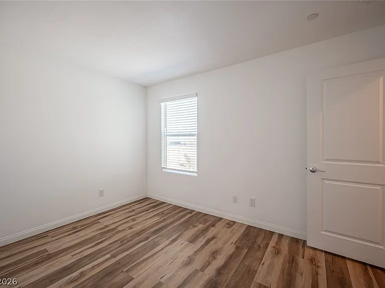 Bedroom 2: Bright secondary bedroom with closet and ample natural light.