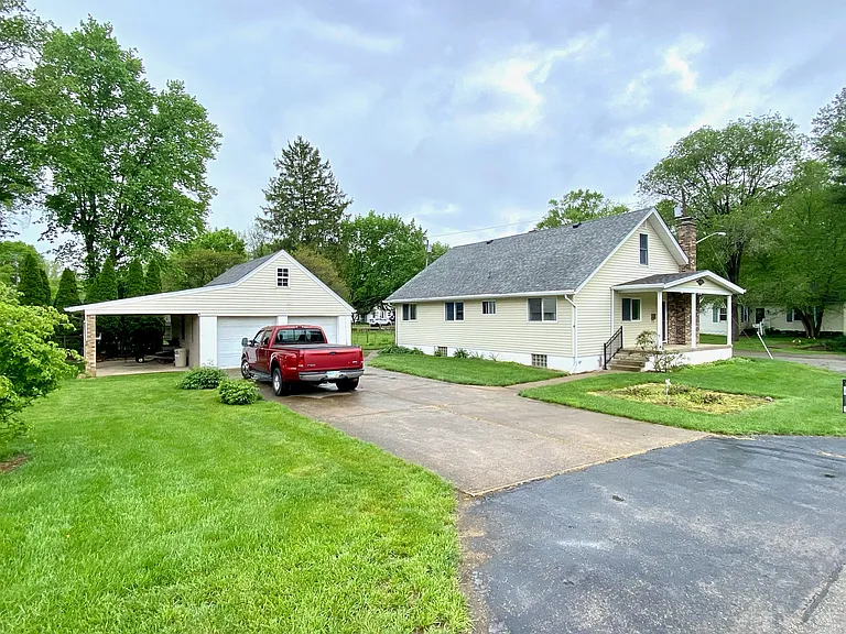 Front of house with garage and side yard
