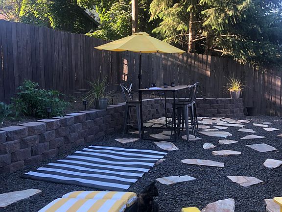 backyard - landscaped half with above ground garden beds (furniture not included)