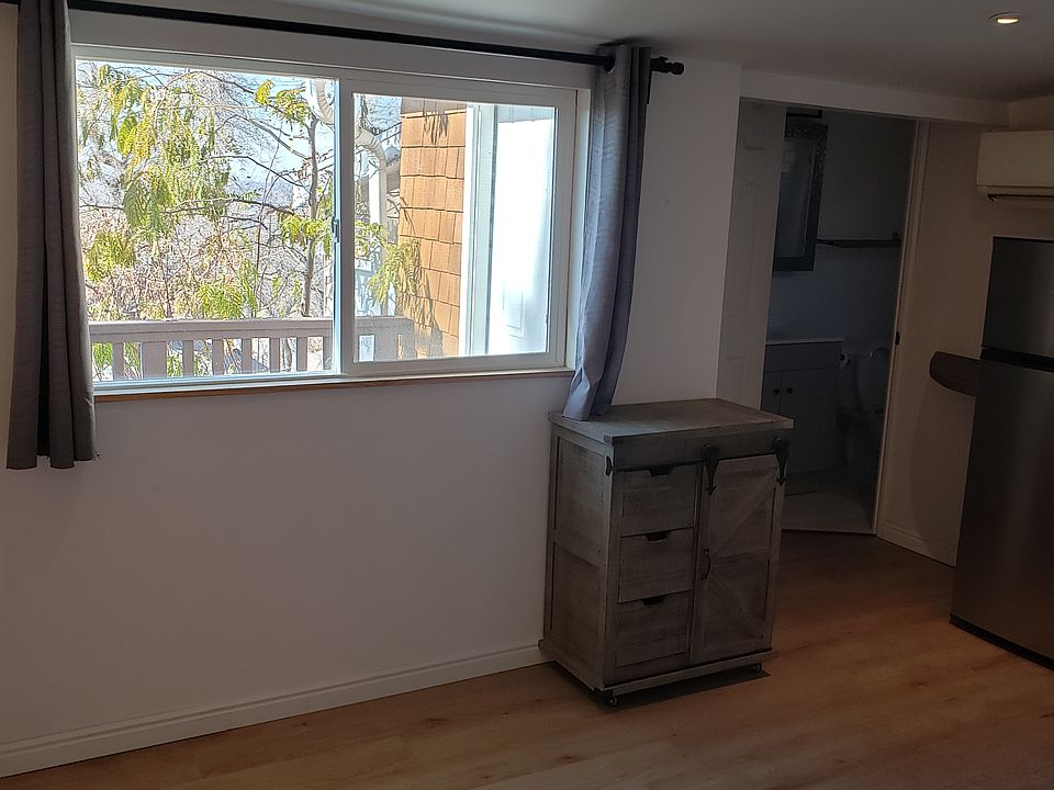 Main living area facing kitchen & bath