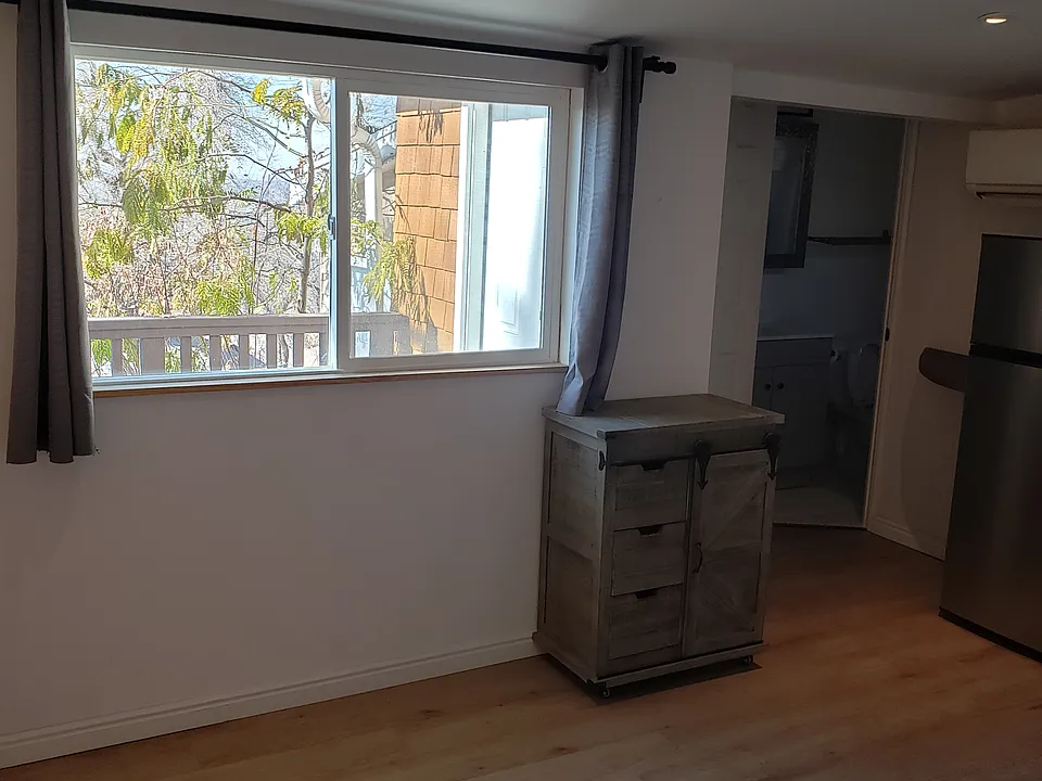 Main living area facing kitchen & bath