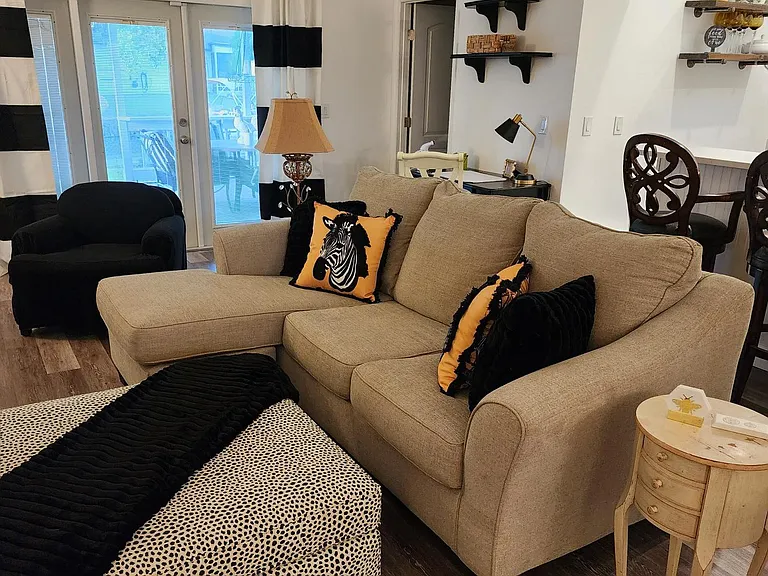 Beautiful comfortable family room with lots of seating. Cozy throws and a large TV for great movies at the end of the day!