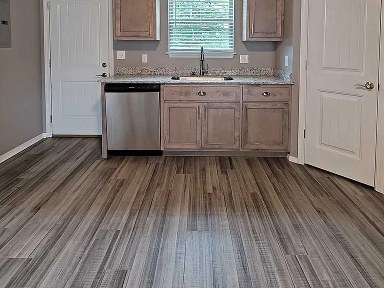 Kitchen, back door leads to shared backyard