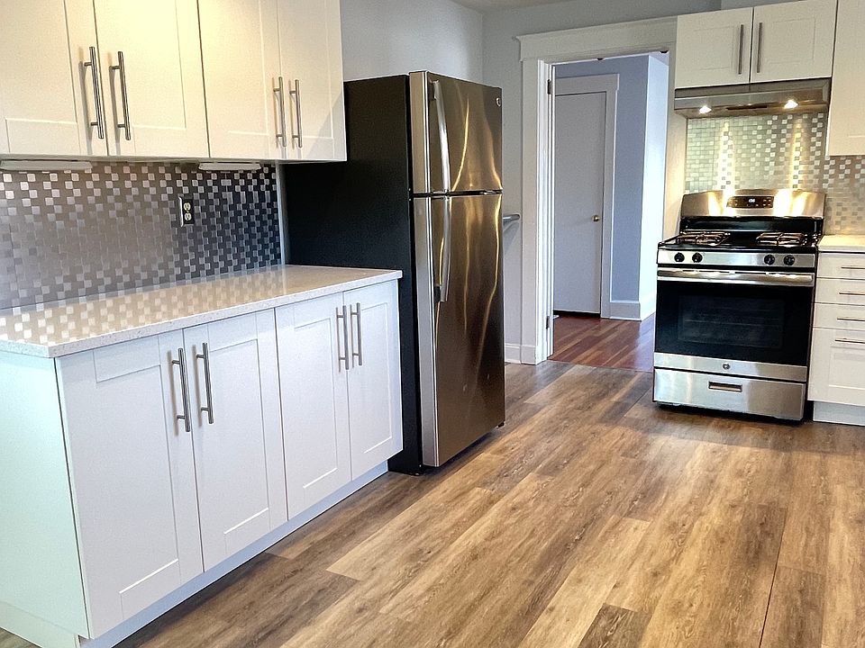 Kitchen view with entry to living room in the distance