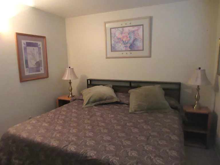 Matching bronze lamps add balance to the king bed with a plush memory foam mattress.
