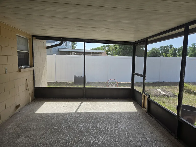 Large covered patio with ample space for outdoor seating and entertaining.
