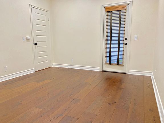 Main floor bedroom with exit door directly leads to outdoor