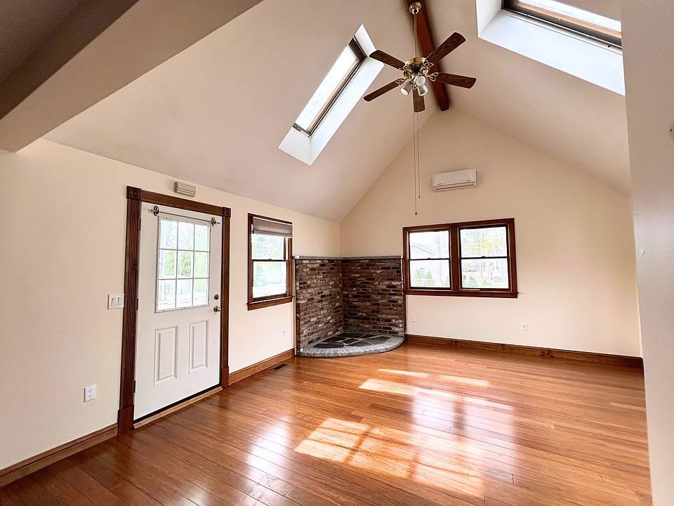 Living/Dining area with access to private back deck, ceiling fan with lights on dimmers, skylights