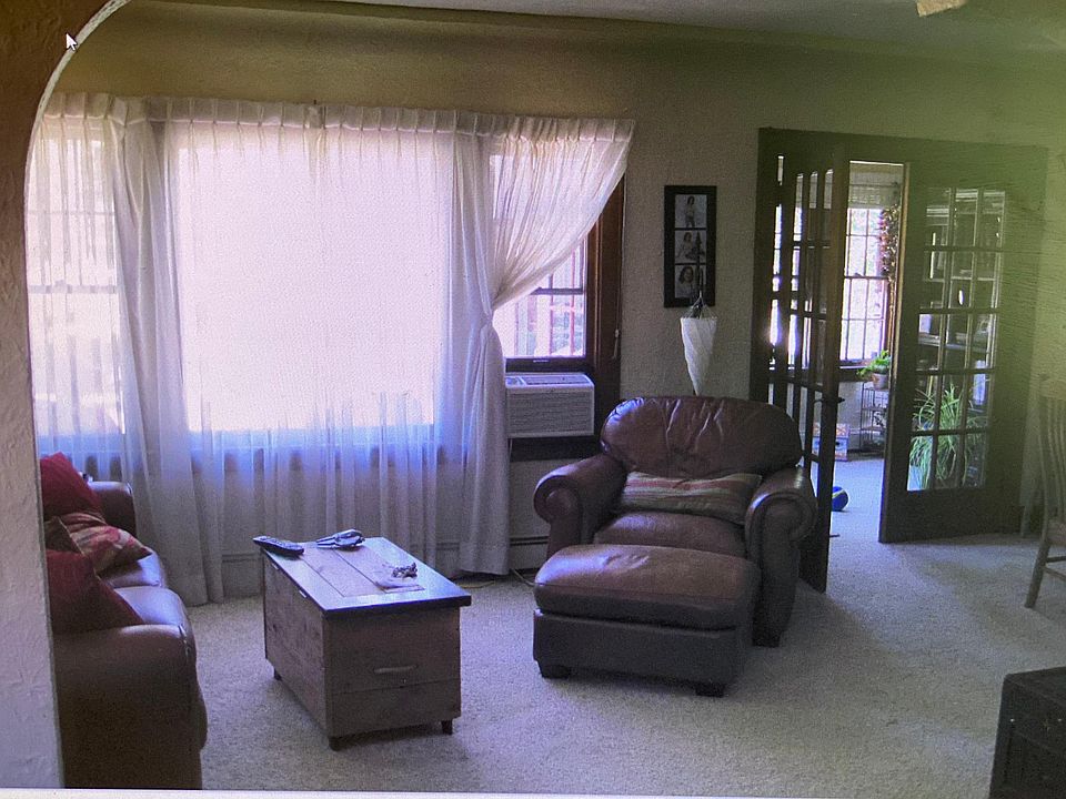 Looking into living room and sunroom through double doors