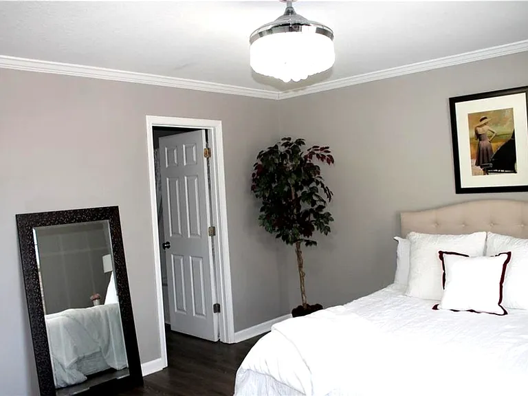 Bedroom #1: vinyl plank flooring and a modern remote-controlled chandelier with retractable fan.