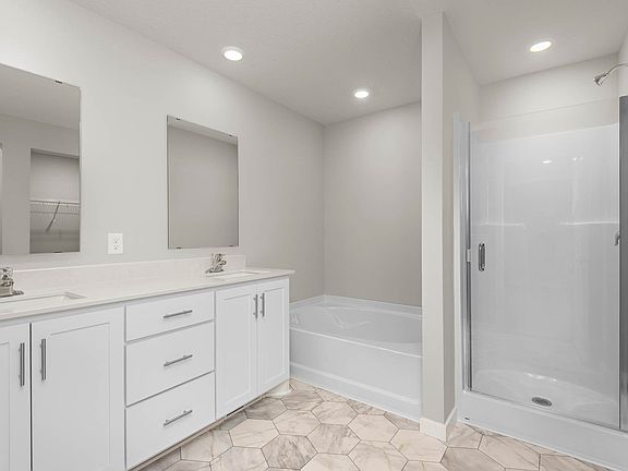 The master bathroom has a soaking tub and a step in shower.