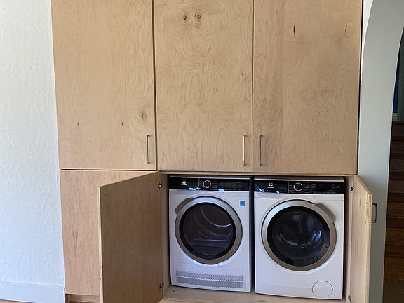 Tons of storage in custom cabinetry with in-unit washer and dryer.