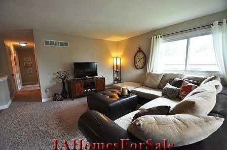Spacious, open Living Room with updated carpet and clean, white trim.