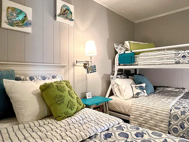 Second bedroom includes 2 twin beds and a full bed with ceiling fan.