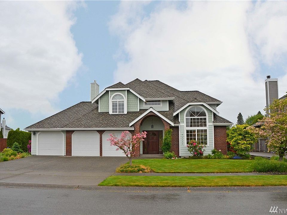 Front of house with 3 car garage.