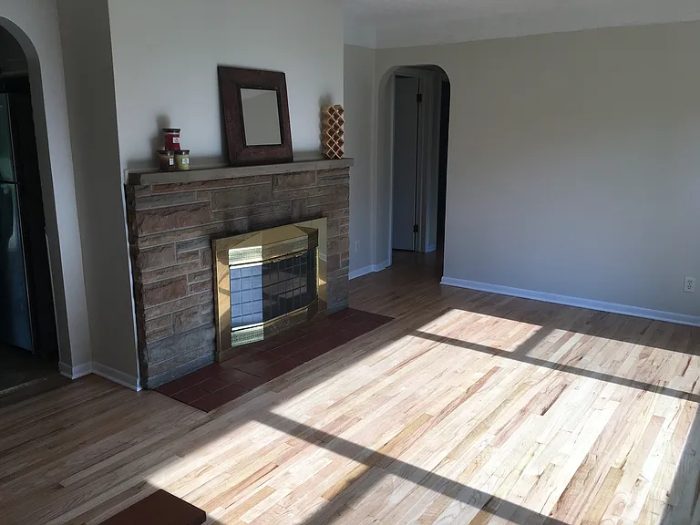 Living room features beautiful original refinished hardwood floors.