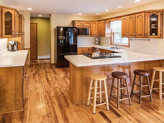 Large kitchen has recently updated appliances, birch cabinetry with an abundance of storage space, hickory hardwood flooring and recessed and under cabinet lighting.