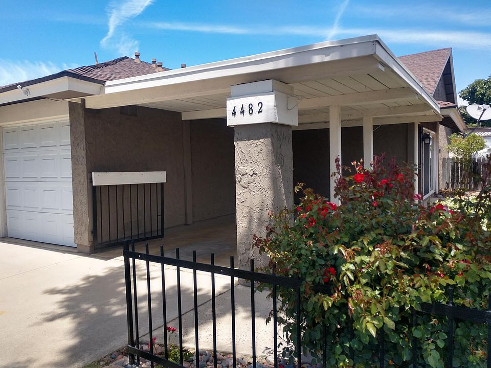 Front of house, garage and carport.