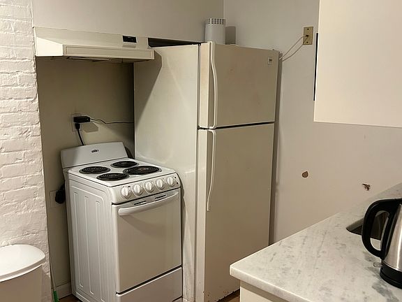 Kitchen with refrigerator and stove.