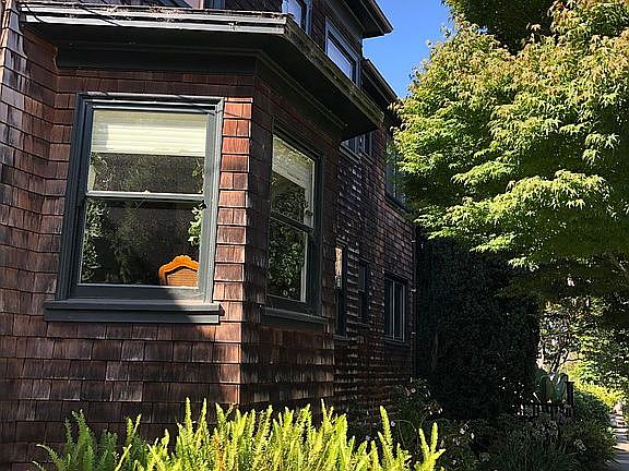 The house is 100 year old brown shingle with two apartments upstairs and one owner-occupied downstairs. There is a shared garden.