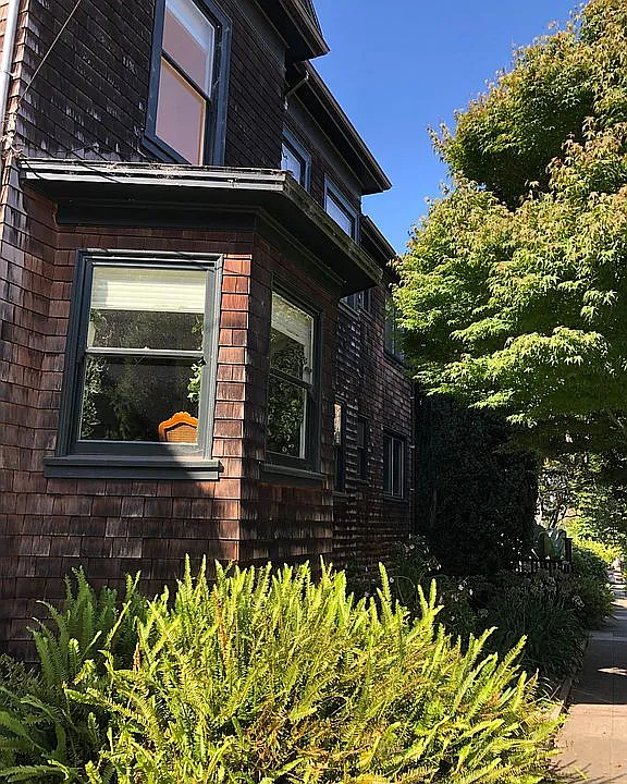The house is 100 year old brown shingle with two apartments upstairs and one owner-occupied downstairs. There is a shared garden.