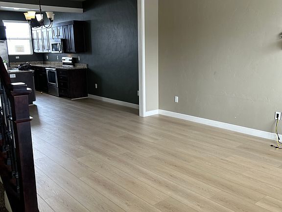Open concept on main level kitchen through living room with half bath off the kitchen