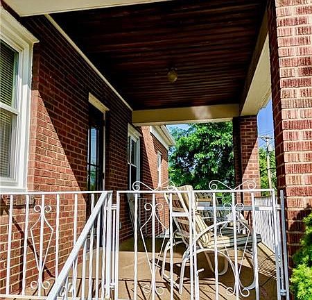 side porch perfect for your morning coffee off the living room.