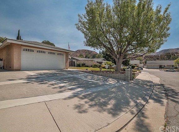 The custom stamped finish concrete driveway allows