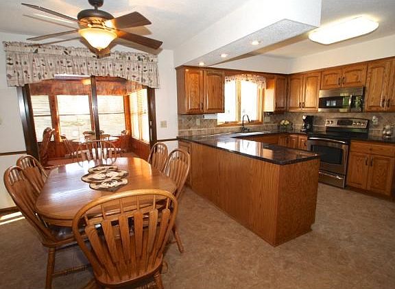 Large kitchen & informal dining area with Duro Ceramic easy maintenance flooring by Congoleum. Access to 4 season porch & deck off dinette.