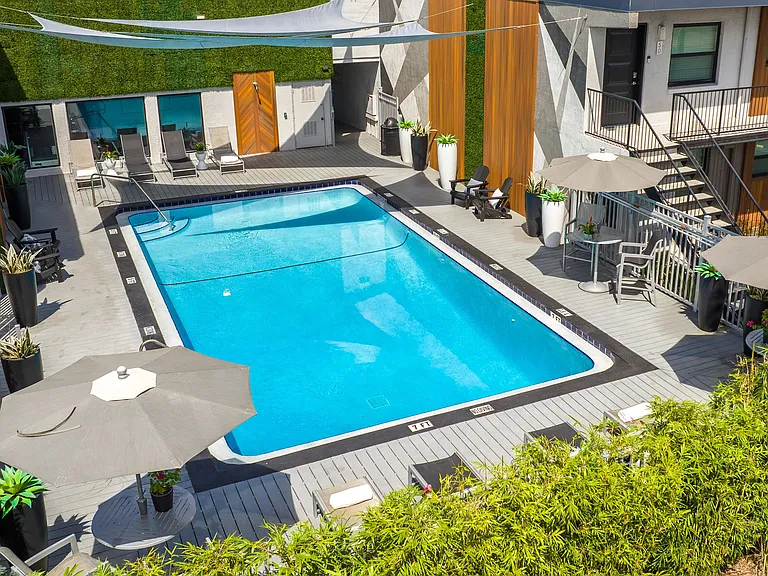 Dive into relaxation at the beautifully designed pool at Elon Winter Park Apartments. Enjoy sunny days in our modern pool area, complete with comfortable lounge chairs and shaded seating.