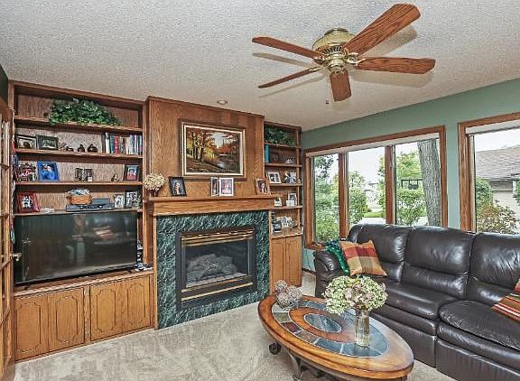 BEAUTIFUL ADDED 4 SEASON PORCH 15 X 13 WITH BUILT IN BOOK CASES AND GAS FIREPLACE!