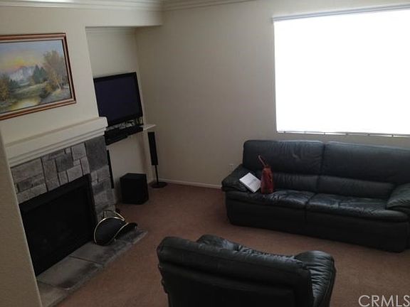 View of cozy living room with large window.