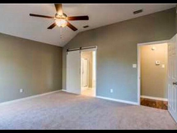 Master Bedroom with barn door entrance to Master Bath