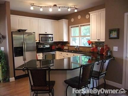 Kitchen : New granite, appliances, travertine backsplash, breakfast bar, designer lighting